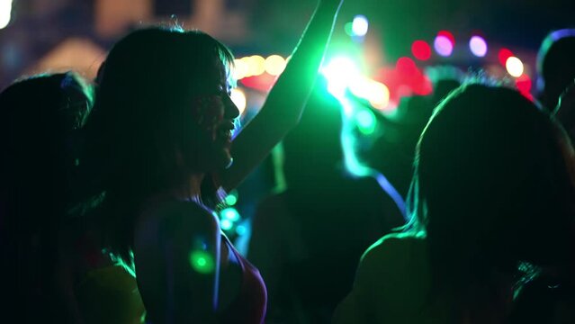 4K Group of Asian woman celebrating and dancing together at tropical island beach full moon party at night. Happy girl friends enjoy outdoor lifestyle beach holiday summer travel vacation in Thailand