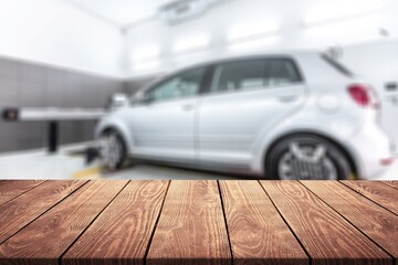 Empty table top with car service centre auto repair workshop blurred background