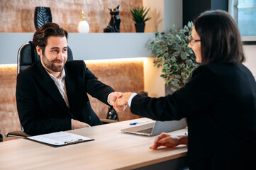 Cooperation, agreement. Successful caucasian business colleagues, entrepreneurs, directors, sit at...