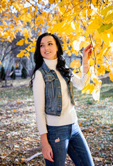 beautiful brunette smiling woman in autumn park