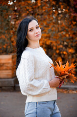 beautiful brunette smiling woman in autumn park