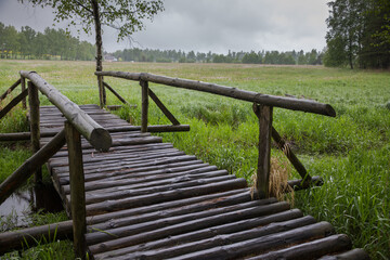 wet wooden footbridge by the bog on a rainy day