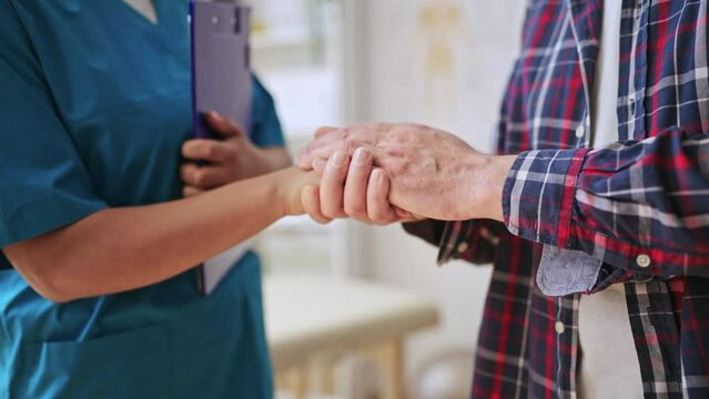 Closeup of doctor and patient shaking hands, medical consultation, teamwork