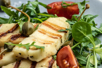 halloumi cheese salad with arugula and tomatoes. ketogenic paleo diet. Delicious breakfast or snack, Clean eating, dieting, vegan food concept. top view