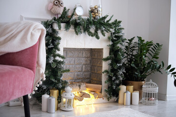 cozy corner with a fireplace decorated with Christmas decorations. Fireplace in room with Christmas decorations. Interior design
