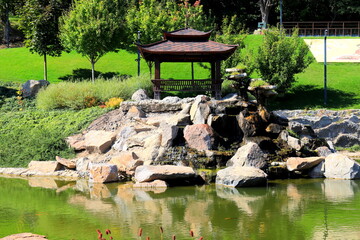 Naklejka premium beautiful landscape park, lake, wooden pavilions in Japanese style. Garden architecture, Uman, Ukraine