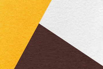 Fototapeta premium Texture of craft white, yellow and dark brown shade color paper background, macro. Vintage abstract cardboard