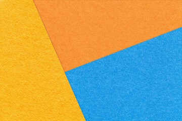 Fototapeta na wymiar Texture of craft yellow, blue and orange shade color paper background. Structure of vintage abstract cardboard