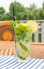 cold mojito cocktail with mint lime and ice in a restaurant on the table