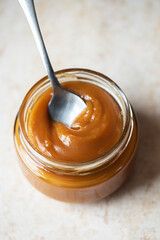 Homemade creamy caramel in a jar. Close up.