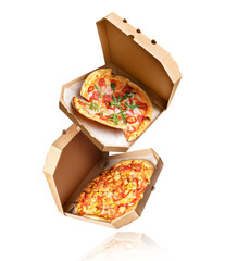 Two baked pizza with in a cardboard boxes in the air on a white background