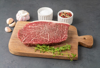 Raw wagyu shoulder roast meat over wooden board with seasonings