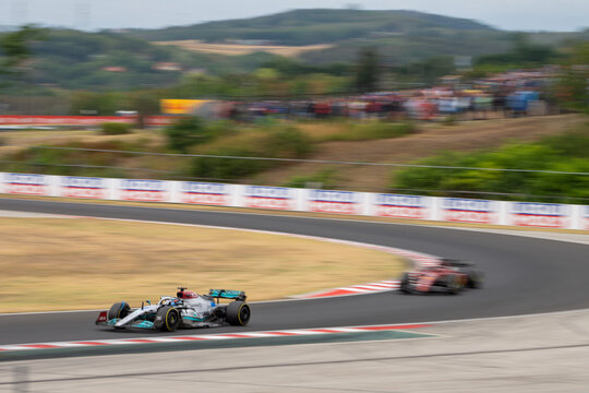 2022 Formula 1 Car at the Hungarian Grand Prix Race - Mercedes and Ferrari - George Russell leads Carlos Sainz - Race Day - Cornering - Motion Blur