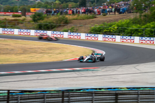 2022 Formula 1 Car at the Hungarian Grand Prix Race - Mercedes and Ferrari - George Russell leads Carlos Sainz - Race Day - Cornering