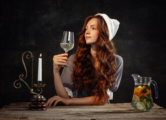 Vintage style. Young charming redhair girl with long curly hair like girl of renaissance eras...