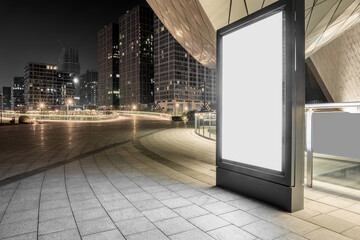 Fototapeta premium Blank billboard on modern city square at night