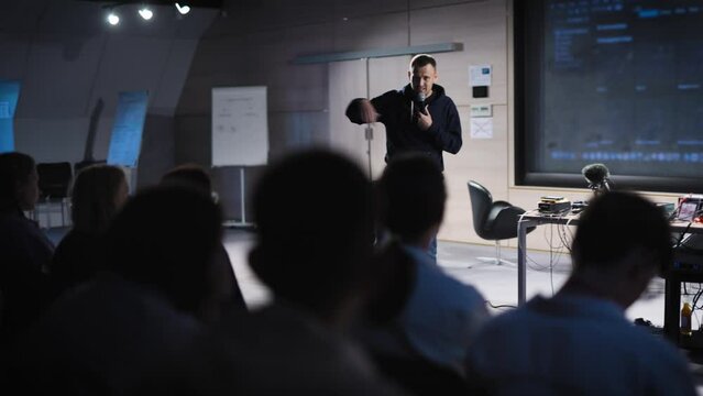 Conference in the IT industry. A young and successful male speaker talks about modern solutions to students and colleagues.
