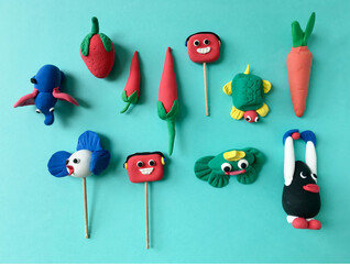 Various colorful models of animals and fruits made by kids using soft clay dough. Cute and colorful...