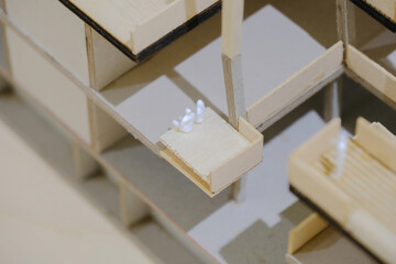 Super close up view of sample architectural model with miniature figurines of couple; macro view, selective focus.