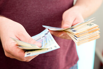 Counting money for a rent. Saving money concept. Finance, business, investment. Keeping savings at home. Spending cash for unexpected expense, unplanned losses, real estate, debts, taxes.
