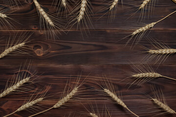 Wheat ears bunch on rustic wooden background.