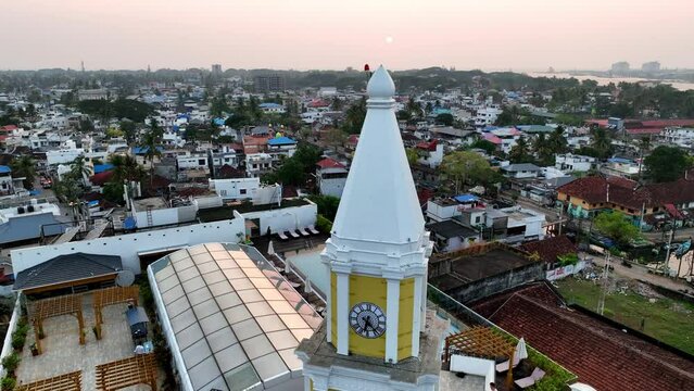 Aerial Panning Shot Of Clock On Tower In Residential City During Sunset - Kochi, India