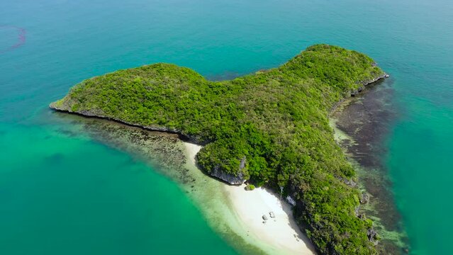Tropical island with white sandy beach in the turquoise waters, view from above. Quirino Island, Hundred Islands National Park, Pangasinan, Philippines. Alaminos. Summer and travel vacation concept