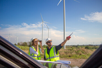 engineer team working in wind turbine farm. Renewable energy with wind generator by alternative energy concept.