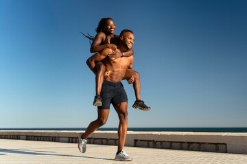 Young multiracial couple enjoying summer training near the ocean