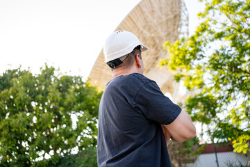 Engineer looking earth based astronomical radio telescope