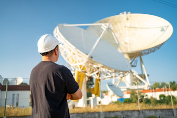 Engineer looking earth based astronomical radio telescope