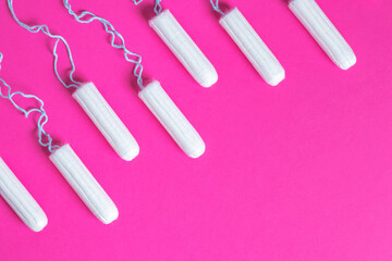 Menstrual period concept. Woman hygiene protection. Cotton tampons on pink background.
