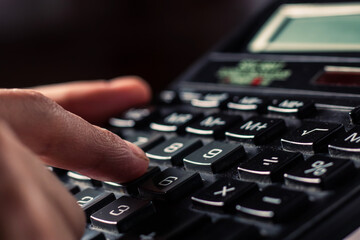 Obraz premium Close up businessman hand using calculator calculate about finance accounting at coffeeshop outdor.