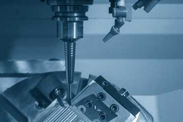 The 5-axis CNC milling machine  cutting the metal mold part.