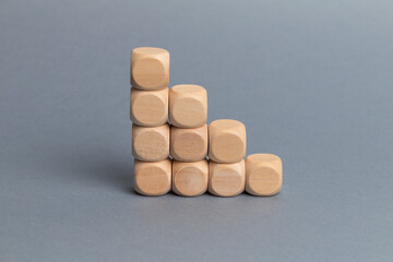 Wood block step stair of pyramid on gray background. Business concept for growth success process. Slide for presentation. Steps. Minimalism. Simple shapes geometry. Blank space for your text.