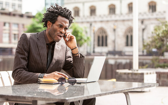 Working Outdoors. A Young London Business Professional Enjoying Working Out Of The Office. From A Series Of Related Images With The Same Model.