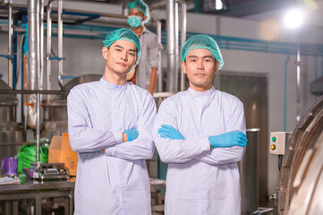 Confident Asian man employee working in food Factory industry , Asia Worker work in food factory