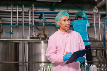 Confident Asian man employee working in food Factory industry , Asia Worker work in food factory