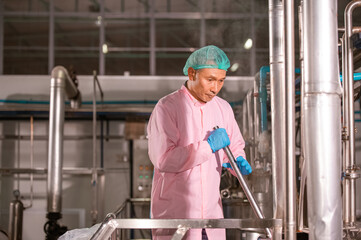 Obraz na płótnie Canvas Asian man employee working in food Factory industry
