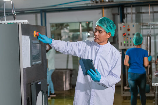 Asian man engineer factory Professional technologist using tablet in production plant checking productivity and quality.