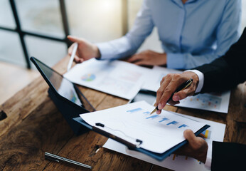 business partnership coworkers analysis strategy with discussing a financial planning graph and company budget during a budget meeting in office room.