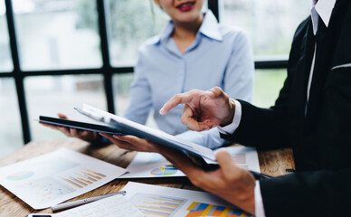 business partnership coworkers analysis strategy with discussing a financial planning graph and company budget during a budget meeting in office room.