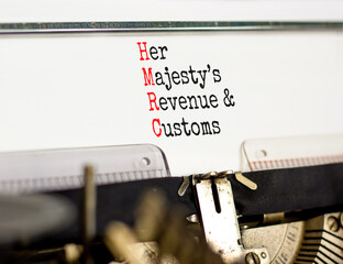 HMRC her majestys revenue and customs symbol. Concept words HMRC her majestys revenue and customs typed on the retro old typewriter. Business HMRC revenue and customs concept. Copy space.