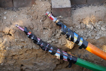 Colorful fiber optic cables laid in the ground, buried cables for faster internet, city of Garbsen...