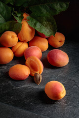 Apricots on a black stone table.