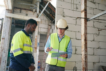 Architect and construction engineer or surveyor discussion plans and blueprints