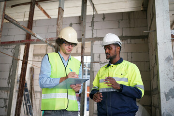 Architect and construction engineer or surveyor discussion plans and blueprints