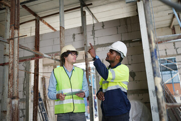 Architect and construction engineer or surveyor discussion plans and blueprints