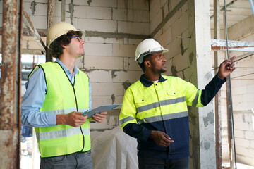 Architect and construction engineer or surveyor discussion plans and blueprints