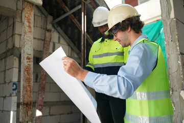 Architect and construction engineer or surveyor discussion plans and blueprints